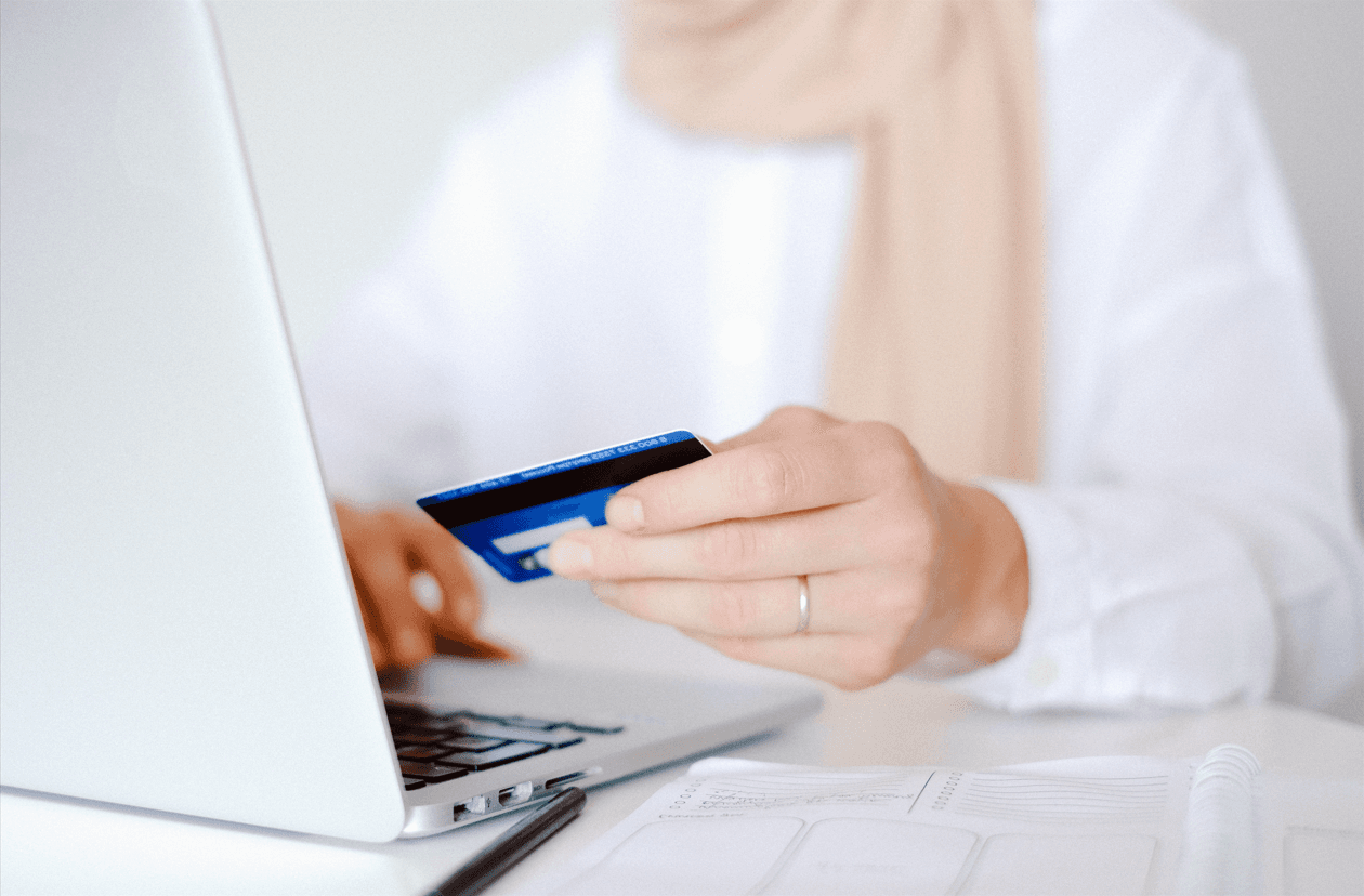 woman entering credit card information on computer