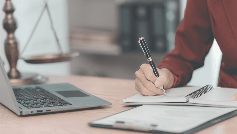 woman writing billing notes at law firm